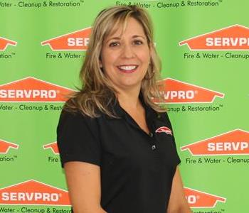 female employee sitting in front of SERVPRO backdrop