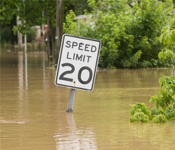 Speed limit sign under water.